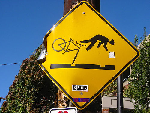 Un cartello di pericolo buche per ciclisti